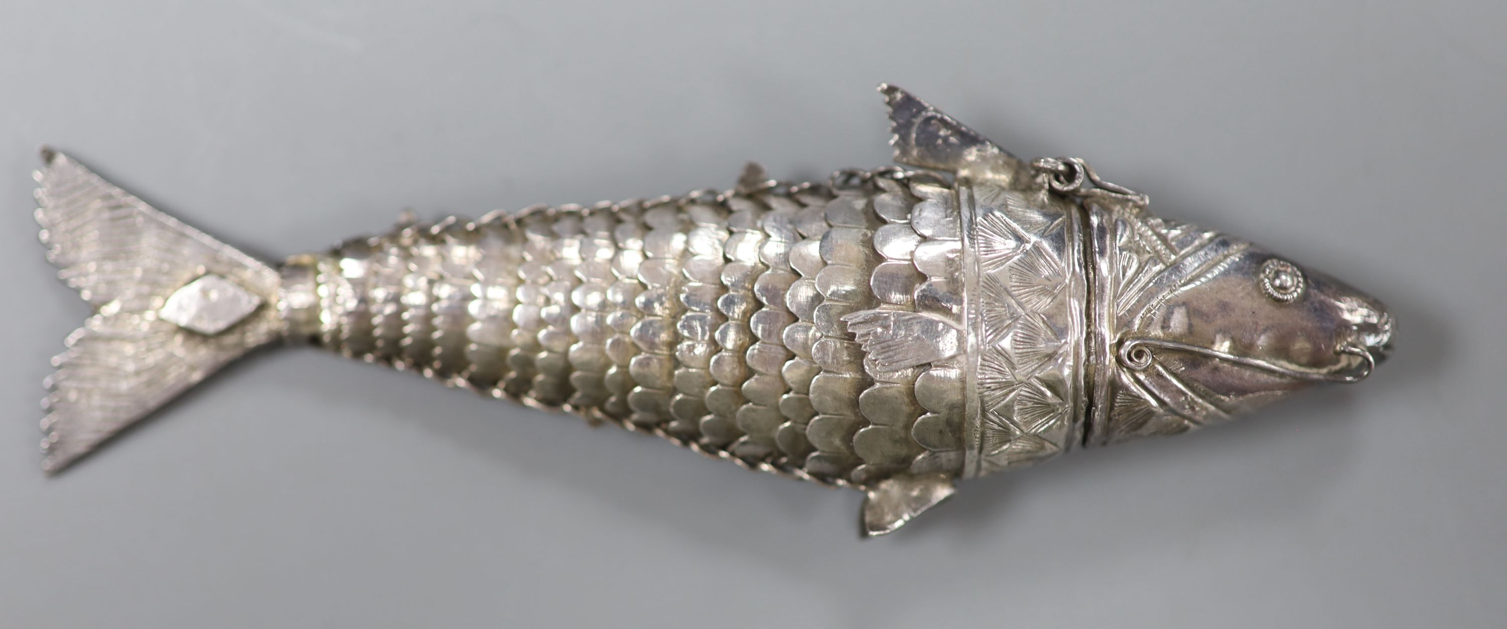 A continental white metal articulated fish pill box, with hinged head
